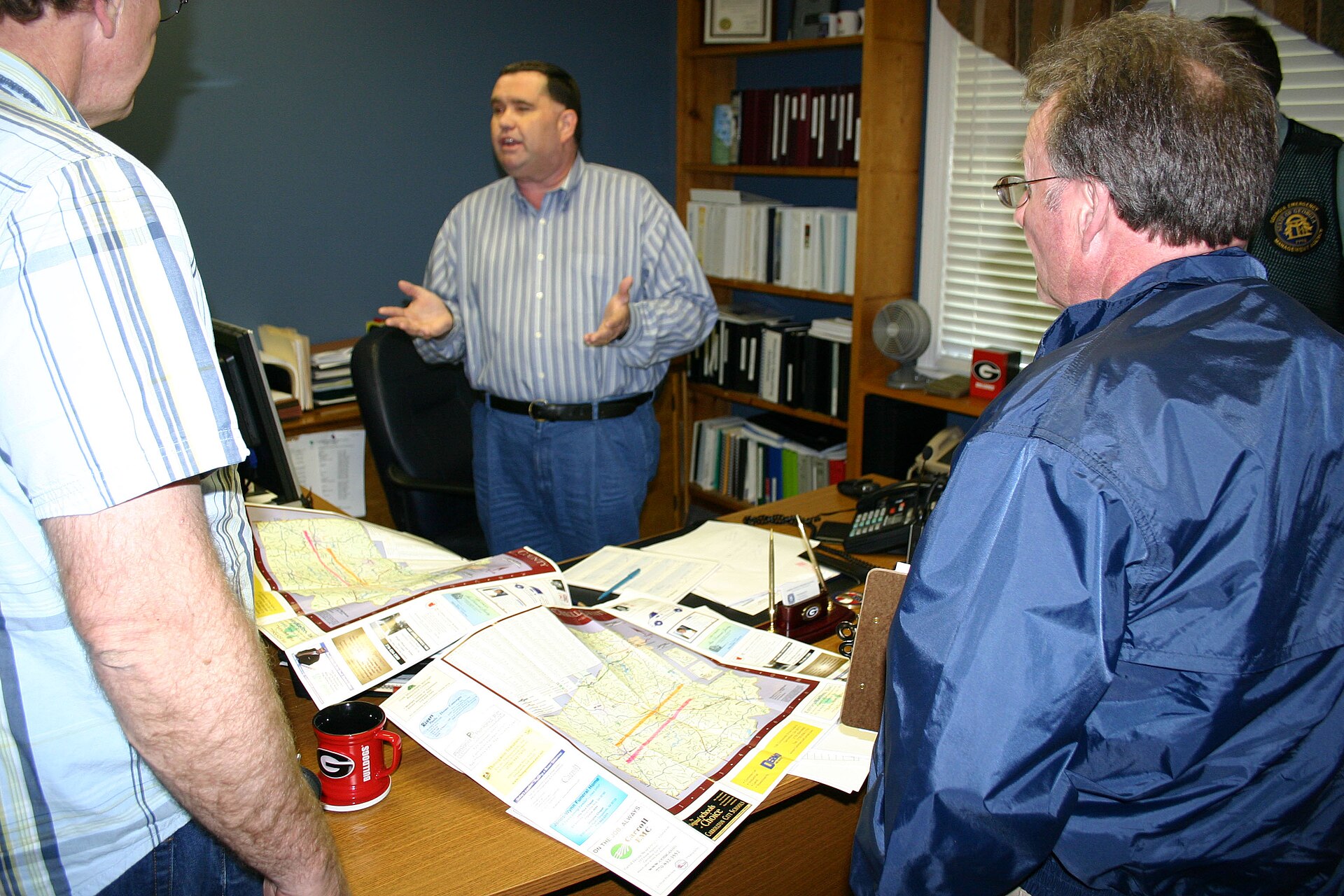 Carroll County, GA, May 12, 2008 -- Members of a Preliminary Damage Assessment Team review maps before heading out to survey areas in Georgia hit by severe storms and tornadoes May 11. Carroll County Emergency Management Agency Director Tim Padgett, center, briefs participants from the state, FEMA and SBA. FEMA/Jeff Welsh