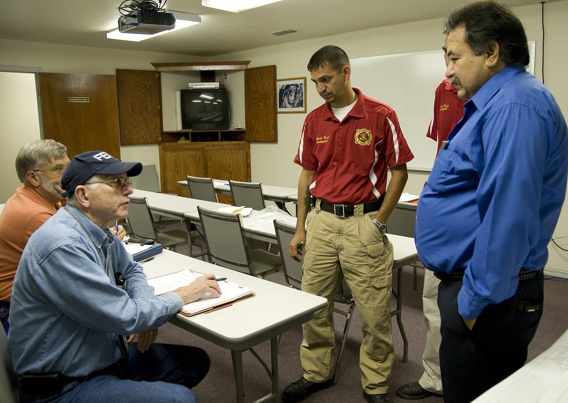 Roma, TX, August 22, 2008 -- Members of the FEMA PDA team talk with City officials about flood damage that occurred following torrential rain that flooded Roma, TX. The PDA team included a FEMA specialist and representatives from SBA and the state of Texas who walked through areas of the town that were flooded. Photo by Patsy Lynch/FEMA