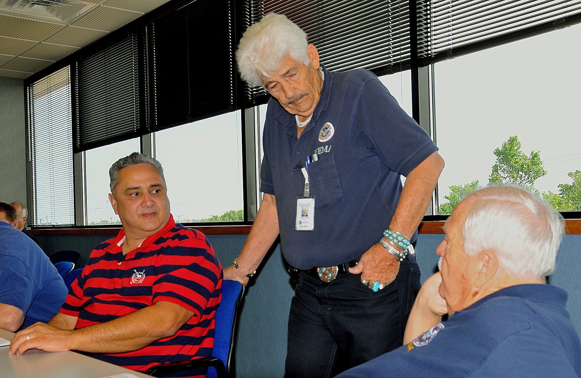 Moore, OK, May 25, 2010 -- Three members of a local/county/state/federal Preliminary Damage Assessment team (left to right) - Sam Talamantez, Oklahoma Office of Emergency Management; Ron Crow, FEMA public assistance officer and Rex Rudy, FEMA's debris management officer - discuss the areas they will look at and document damages for a tornado that struck the area on May 10. Public properties in the eastern half of the state swept by 22 confirmed tornadoes experienced damages from these severe storms. FEMA Photo by Win Henderson